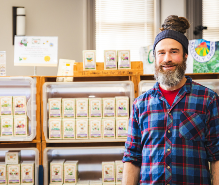 A man stands in front of a display of teas